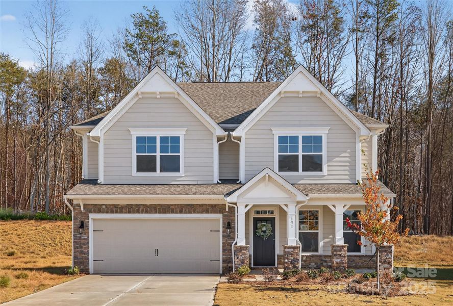 Front exterior of a new home in Falls Cove, Troutman, NC, highlighting curb appeal (Image 1).