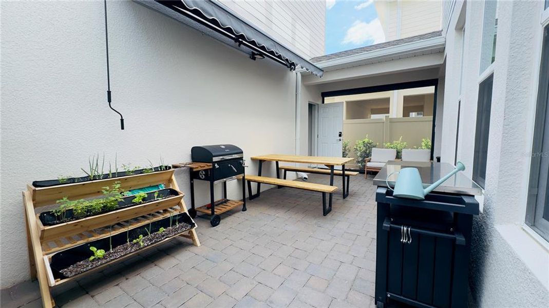 Exterior details and patio area of a home in Harvest at Ovation, Winter Garden (Image 3).
