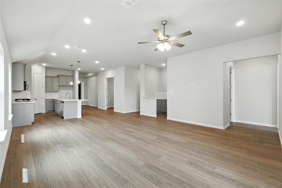 Unfurnished living room with recessed lighting, light wood-style floors, and a ceiling fan