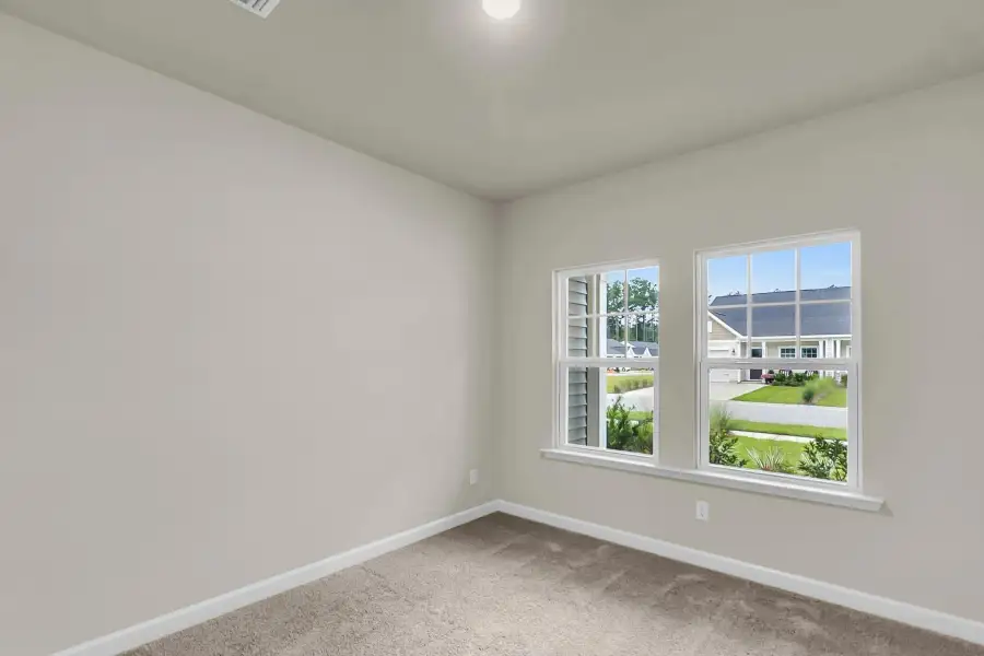 Versatile bedroom with plush carpet and ample closet space.