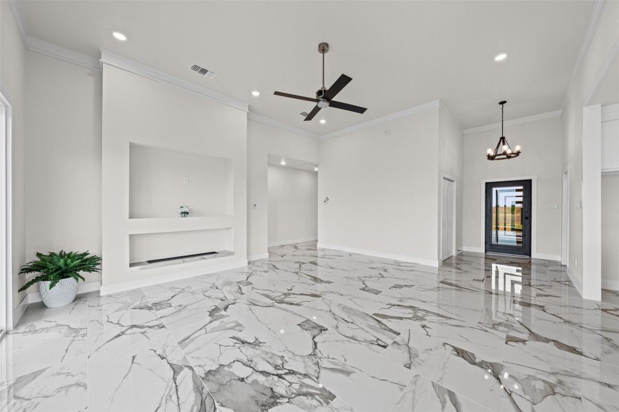 Gleaming marble-look tile floors and soaring ceilings define this airy, open-concept living space.