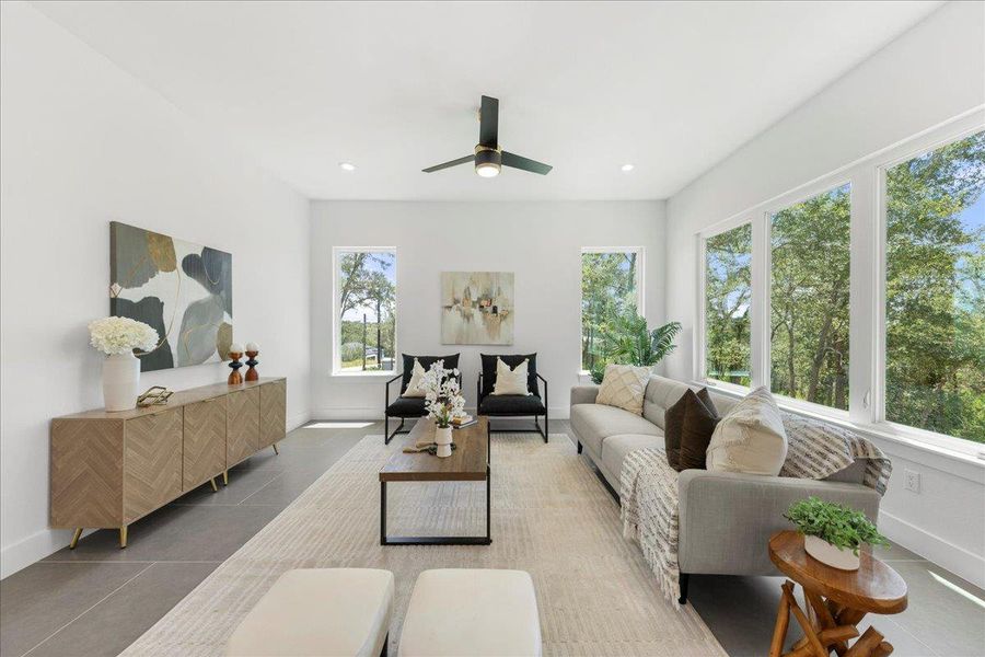 Tiled living room featuring a ceiling fan and recessed lighting Tiled living room featuring a ceiling fan and recessed lighting