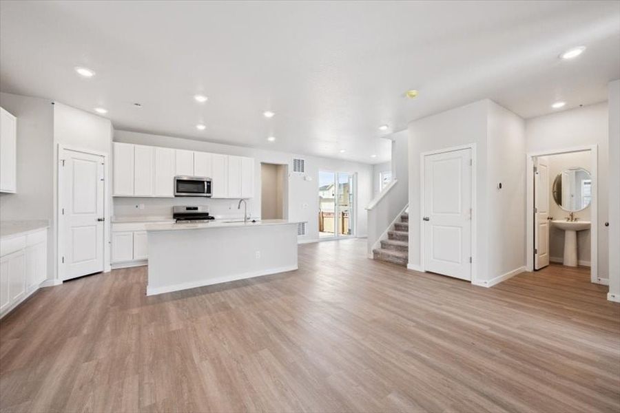 A large kitchen with white cabinets.