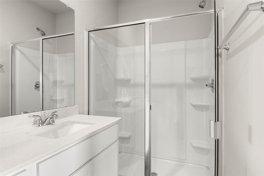 Bathroom with vanity and a shower stall