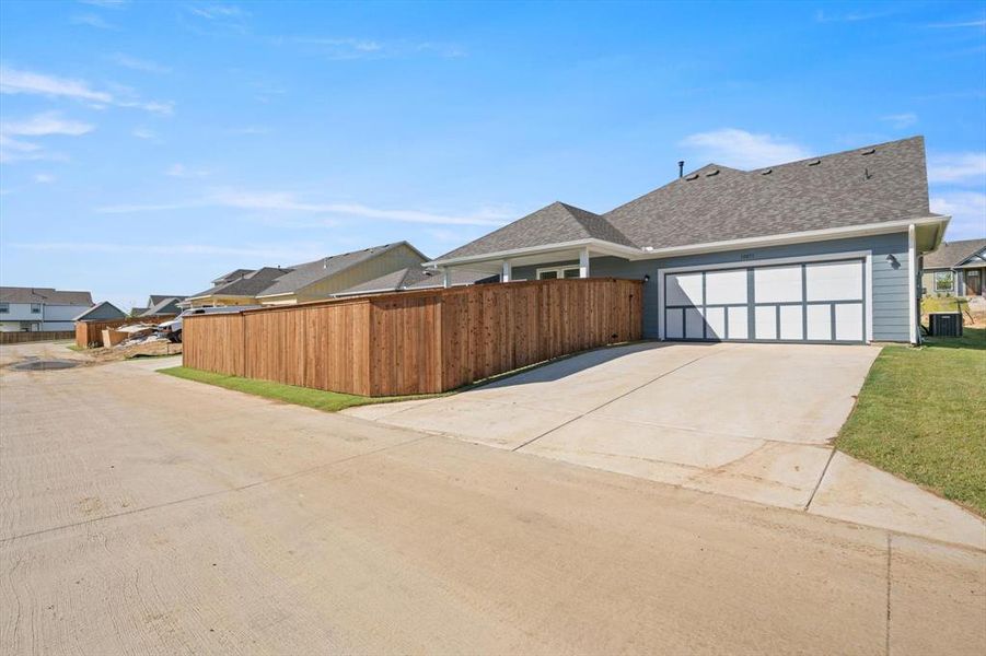 Backview of home with 2 car garage and fenced yard