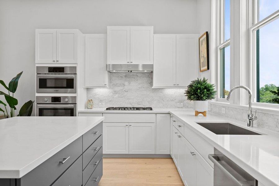 Designer kitchen with built-in appliances, ample storage, and an oversized prep space for entertaining.