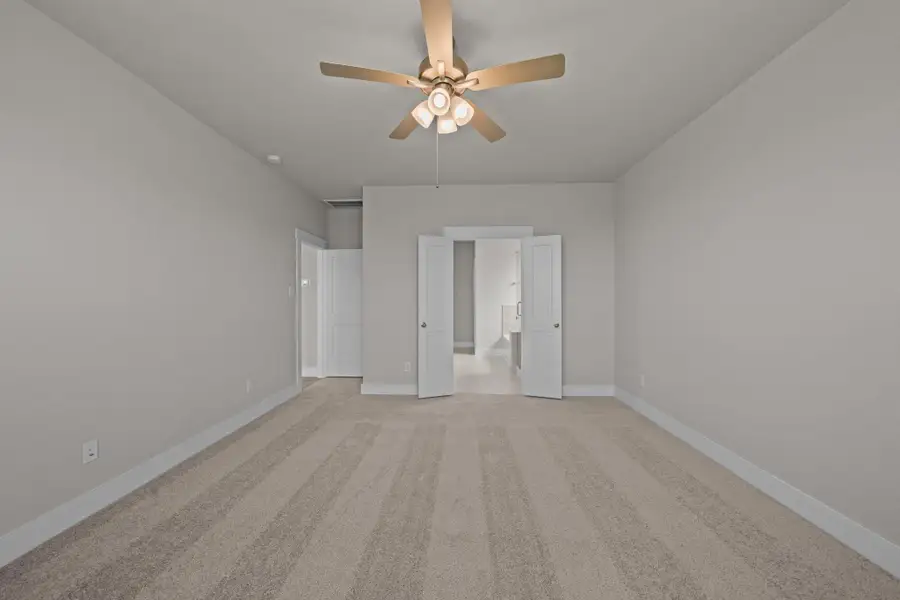 As you enter the primary bedroom, you’re greeted by an abundance of natural light pouring in through large, beautifully framed windows, casting a warm glow on the soft, neutral tones of the walls. REPRESENTATIVE PHOTO