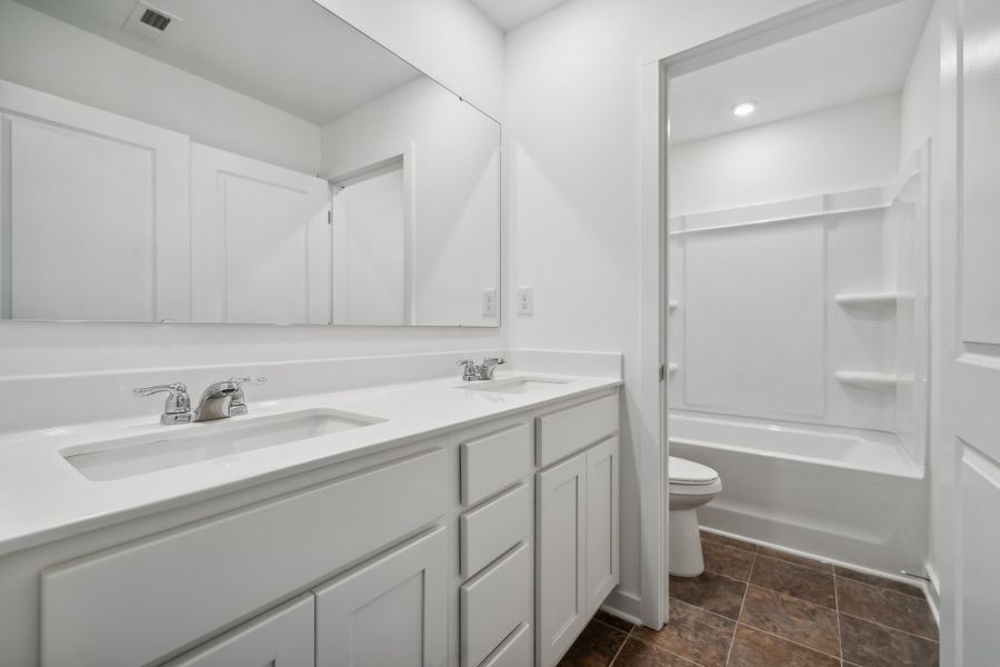 A bathroom with white cabinets. A bathroom with white cabinets.