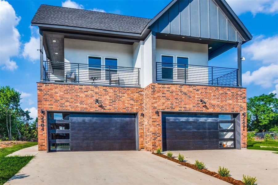 Contemporary home with a balcony and a garage