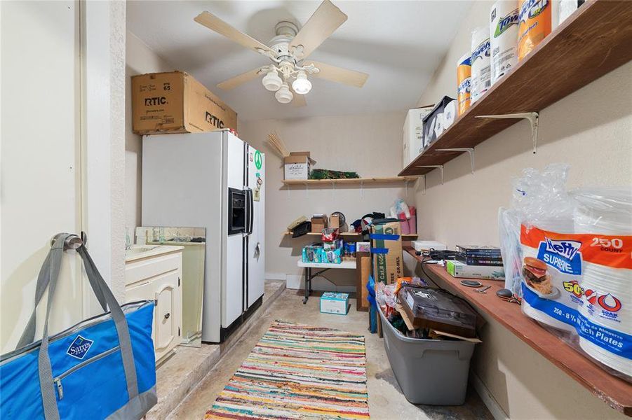 Storage area with ceiling fan in the same room as previous pict.