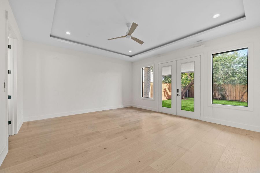 Private and spacious primary suite inviting owner's sanctuary designed for exclusivity. Stunning ceiling treatment and serene views of the backyard retreat welcomes you.
