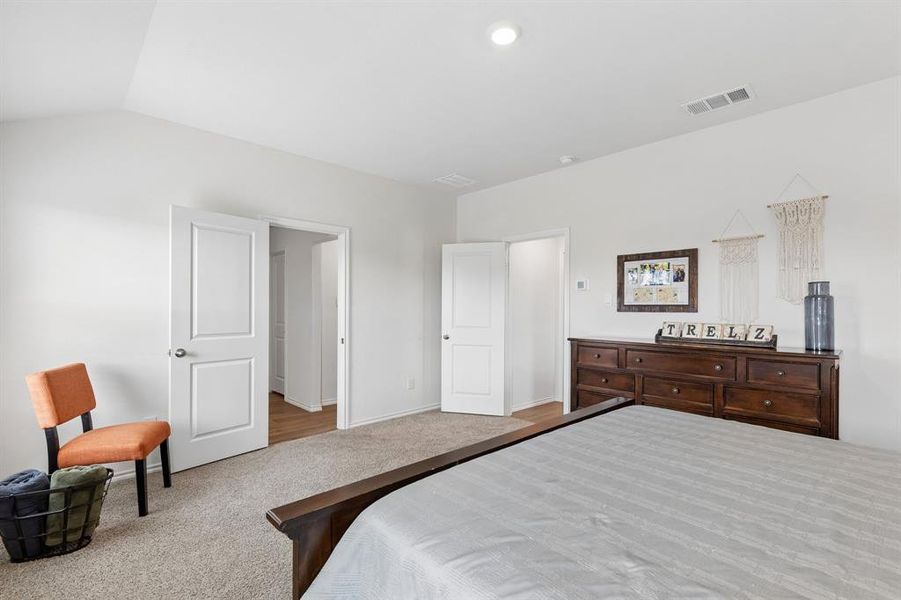 Bedroom with carpet and lofted ceiling Bedroom with carpet and lofted ceiling