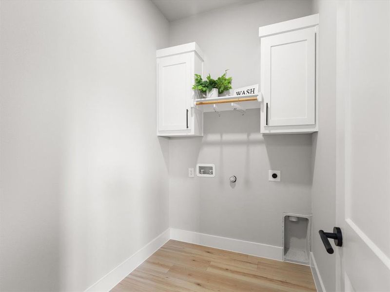 Dedicated laundry area featuring light wood-finish flooring Dedicated laundry area featuring light wood-finish flooring