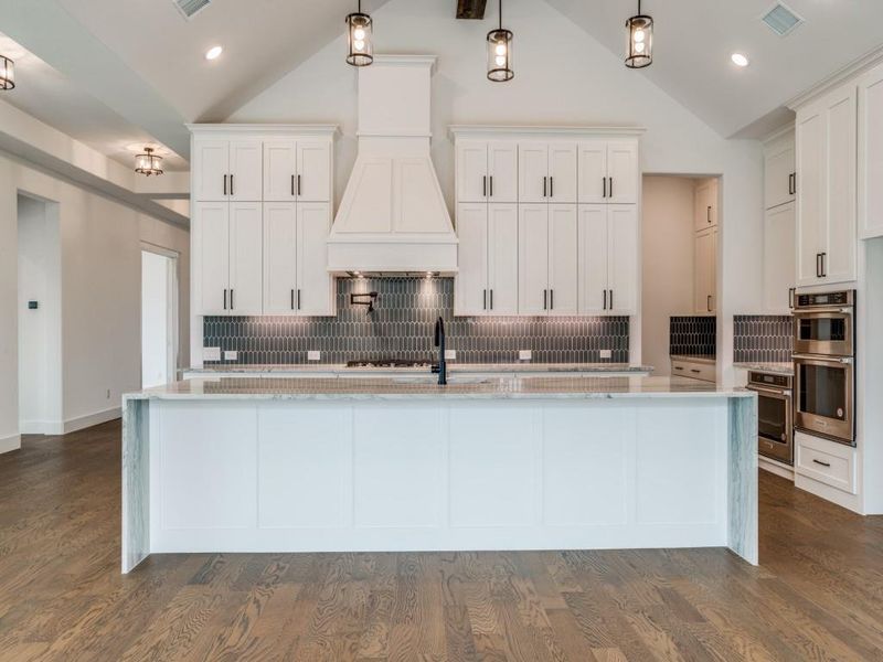 With double stacked cabinets and an oversized island, there is no shortage of style, storage or prep space in this dream kitchen!