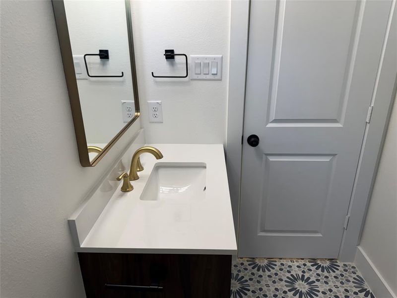 Bathroom with vanity and tile patterned floors