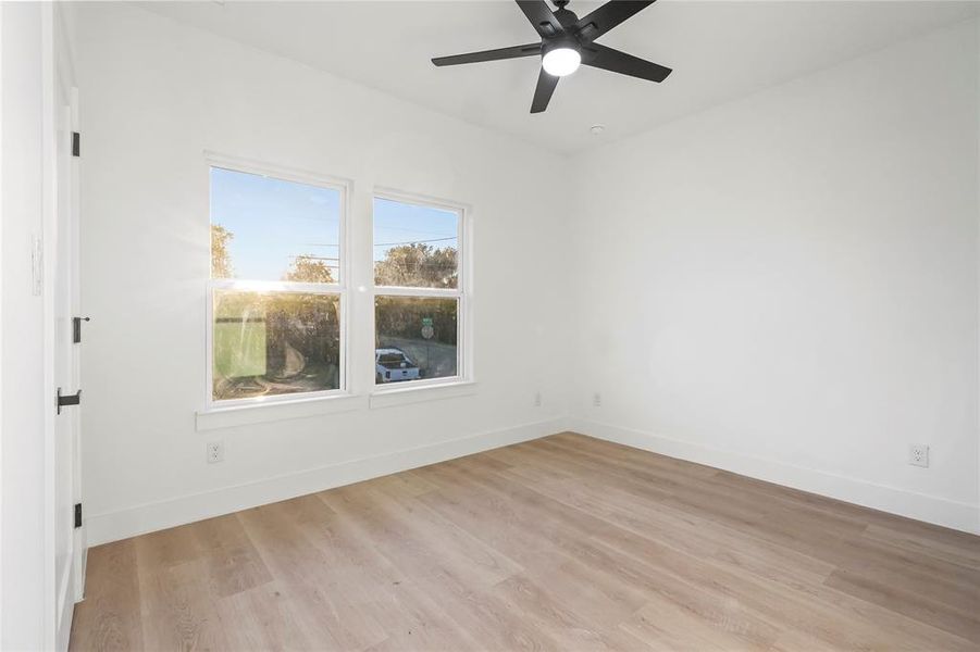 Unfurnished room with light wood finished floors and ceiling fan Unfurnished room with light wood finished floors and ceiling fan