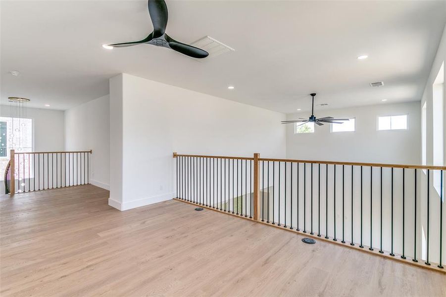 Empty room with ceiling fan, light wood-style floors, and recessed lighting Empty room with ceiling fan, light wood-style floors, and recessed lighting