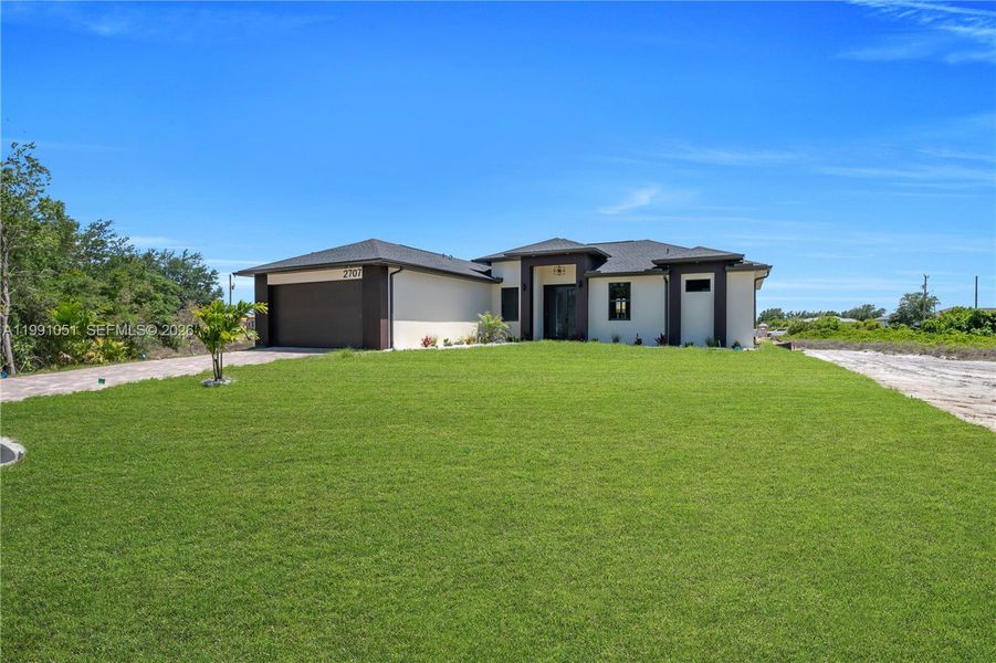 Front exterior of a new home in , Lehigh Acres, FL, highlighting curb appeal (Image 26).