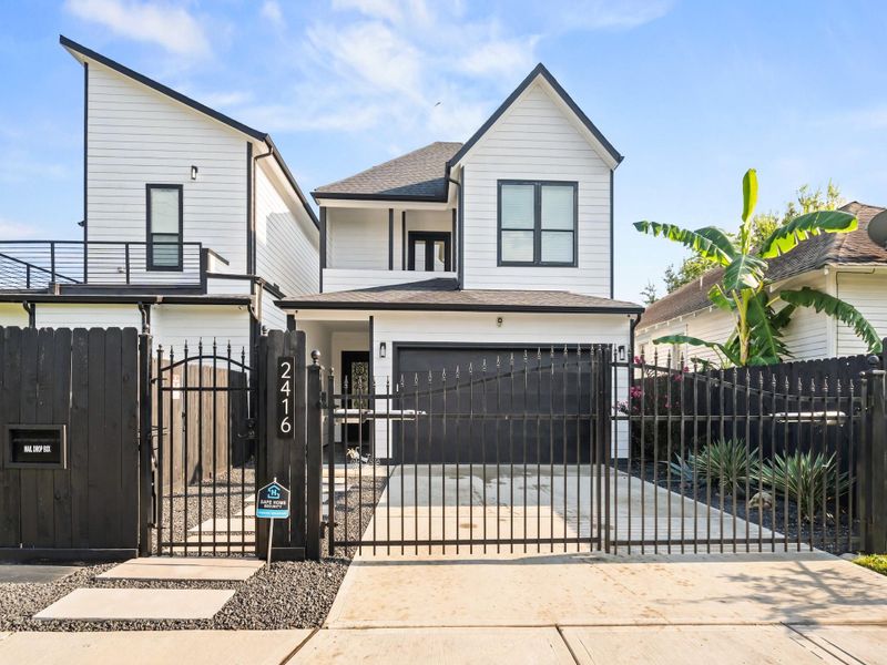Front Elevation, fea. oversized pavers w/ gravel surround, wrought iron-entry gate, (wrought iron,remote-control retractable gate, at driveway,) mail box...cleverly positioned to ensure safe delivery of mail, decreative greenery