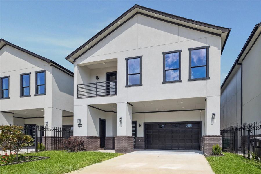 The front elevation stands out with a fresh contemporary profile, defined by smooth stucco, deep-toned accents, and a second-story balcony that adds depth and dimension. The front elevation stands out with a fresh contemporary profile, defined by smooth stucco, deep-toned accents, and a second-story balcony that adds depth and dimension.
