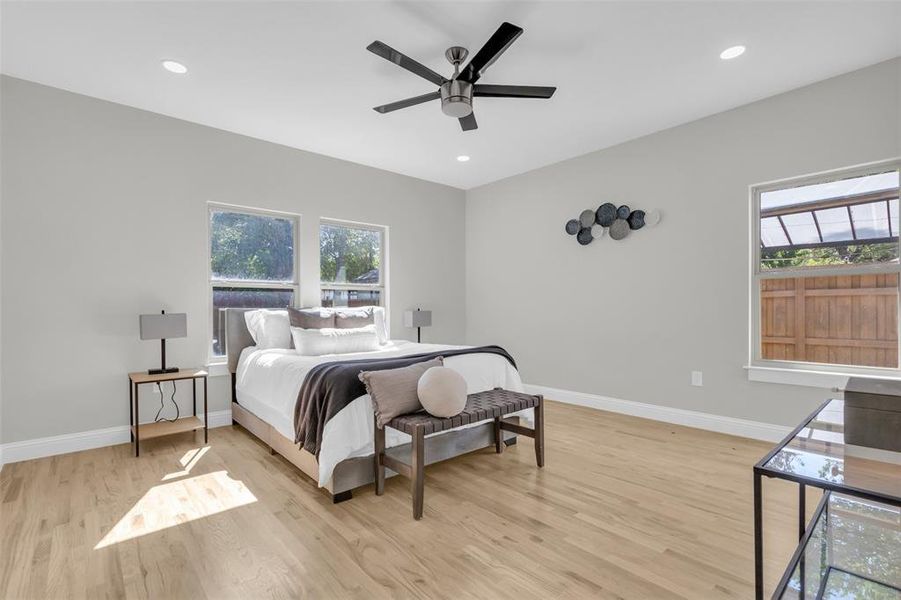 Bedroom with multiple windows, light wood-style flooring, recessed lighting, and a ceiling fan