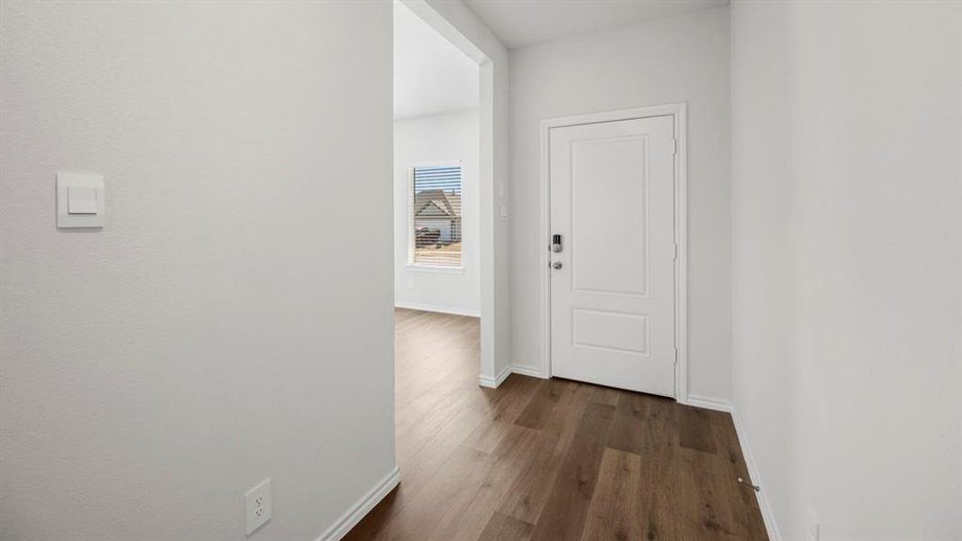 Hallway with baseboards and dark wood finished floors