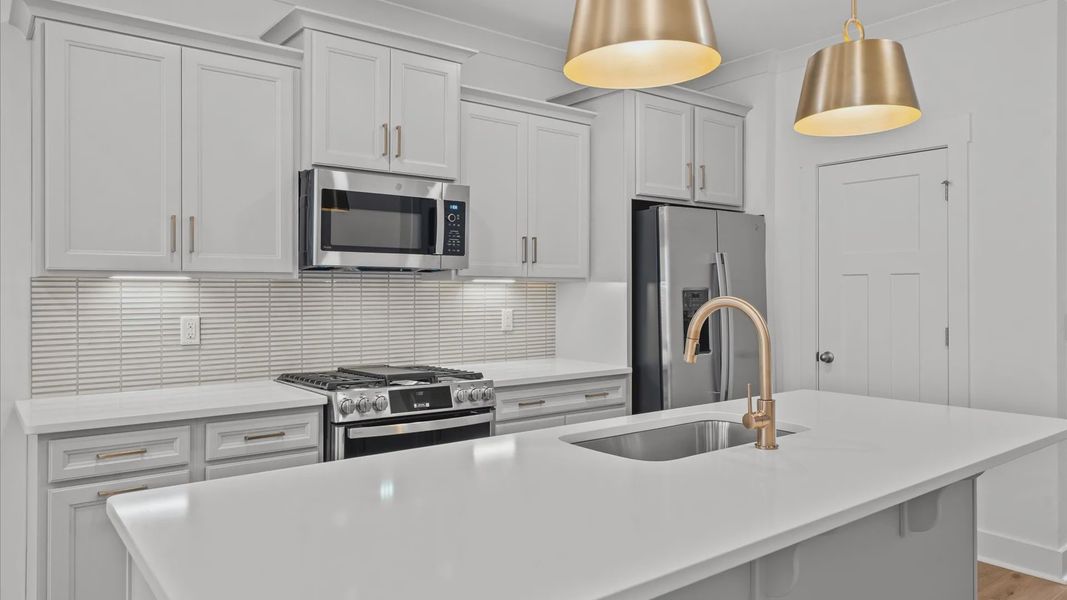 Elegant and compact island anchors this tasteful kitchen with high standards and timeless appeal at Pelham Crossing