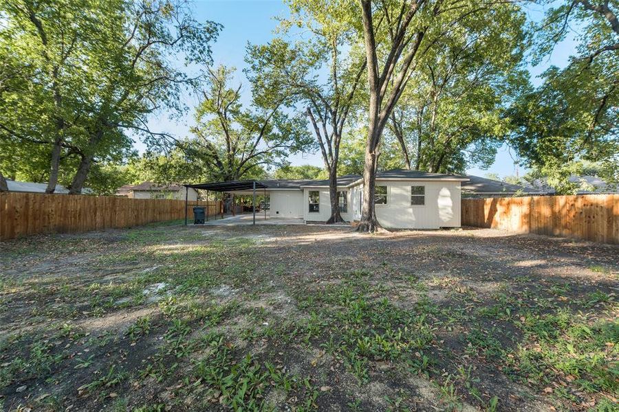 Back of house with a carport