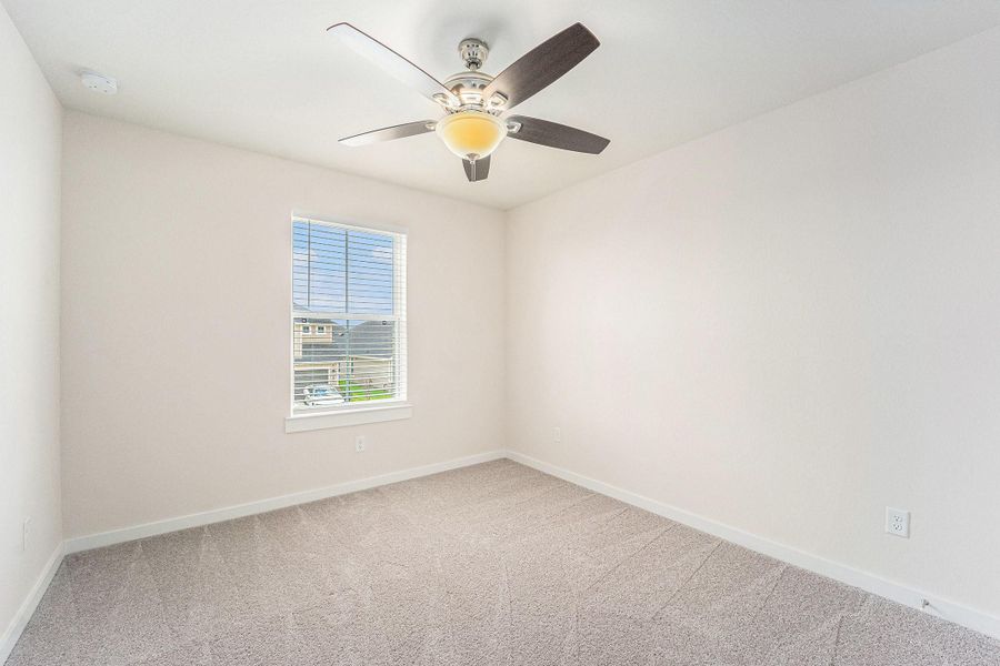 Bedroom 3 is large with neutral paint, a ceiling fan and is light and bright. Bedroom 3 is large with neutral paint, a ceiling fan and is light and bright.