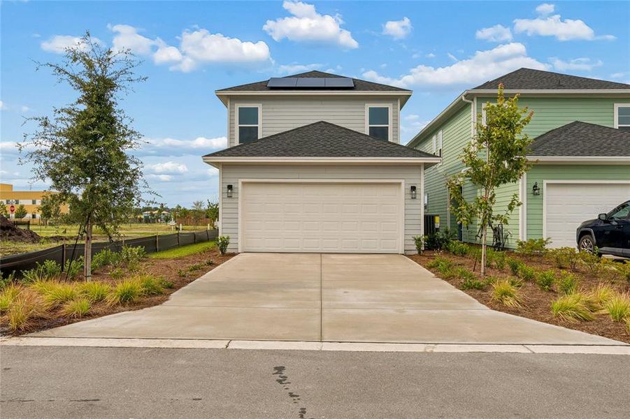 Front exterior of a new home in Weslyn Park in Sunbridge 34', St. Cloud, FL, highlighting curb appeal (Image 20). Front exterior of a new home in Weslyn Park in Sunbridge 34', St. Cloud, FL, highlighting curb appeal (Image 20).