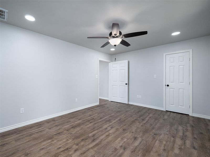 Spare room featuring dark wood-type flooring, recessed lighting, and a ceiling fan