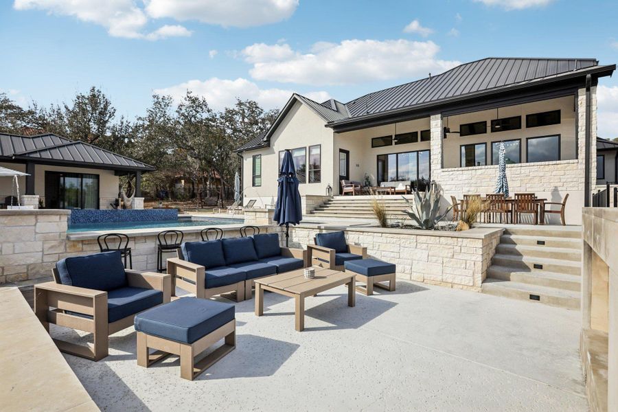 Gather around the outdoor stone fireplace for cozy evenings under the Texas stars.