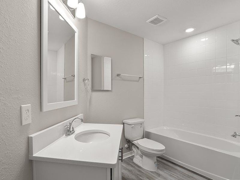 An upstairs hall bath serves bedroom 4, and a downstairs powder room is available for guests - Donatella bungalow by Highland Homes