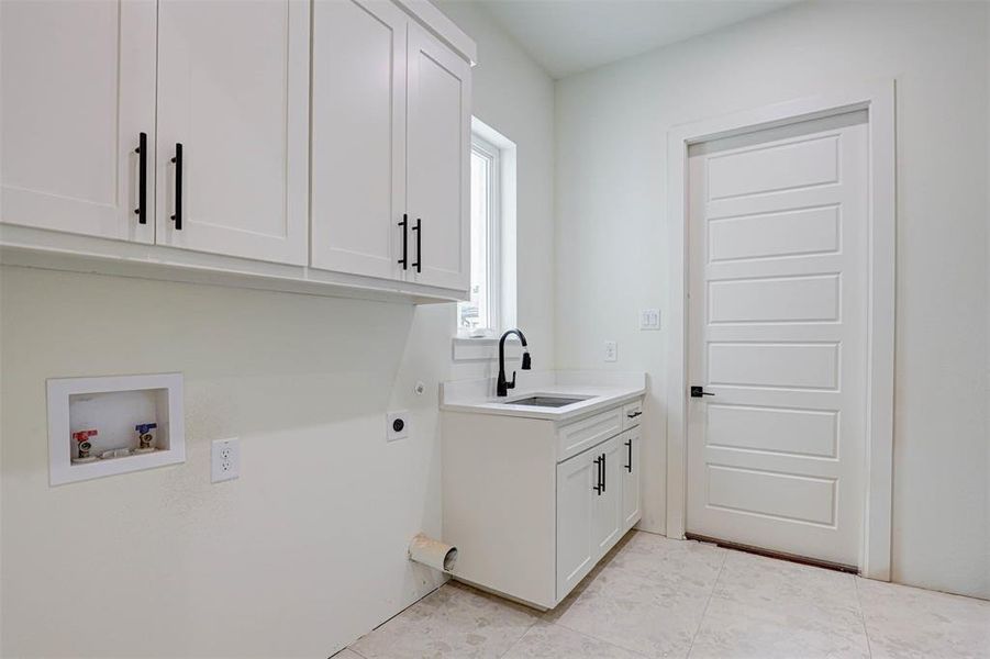 Laundry room featuring cabinet space, washer hookup, electric dryer hookup, and light tile patterned floors
