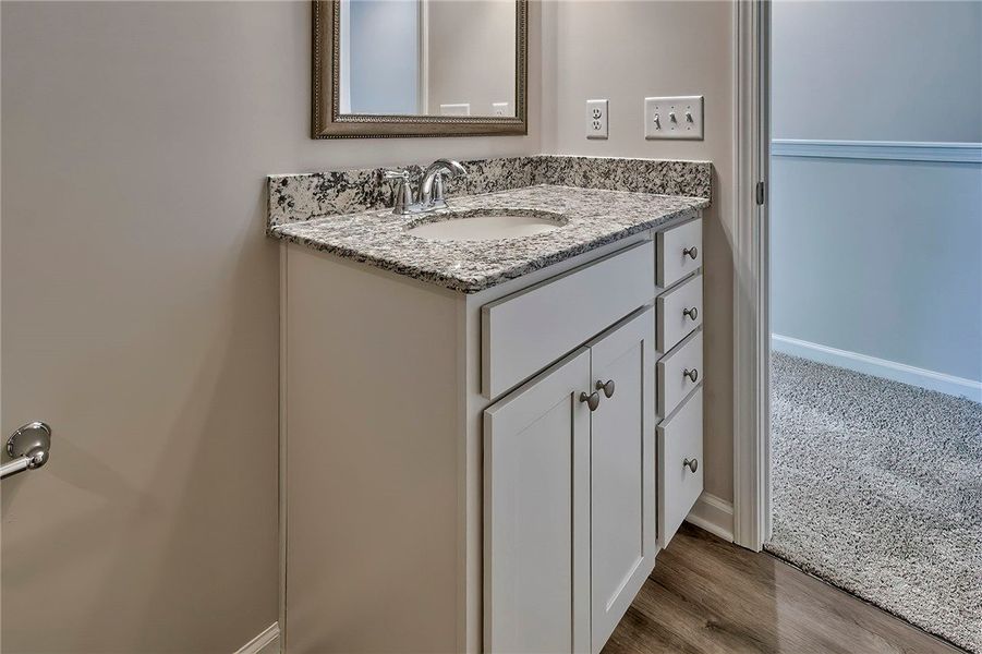 This clean bathroom vanity features elegant granit