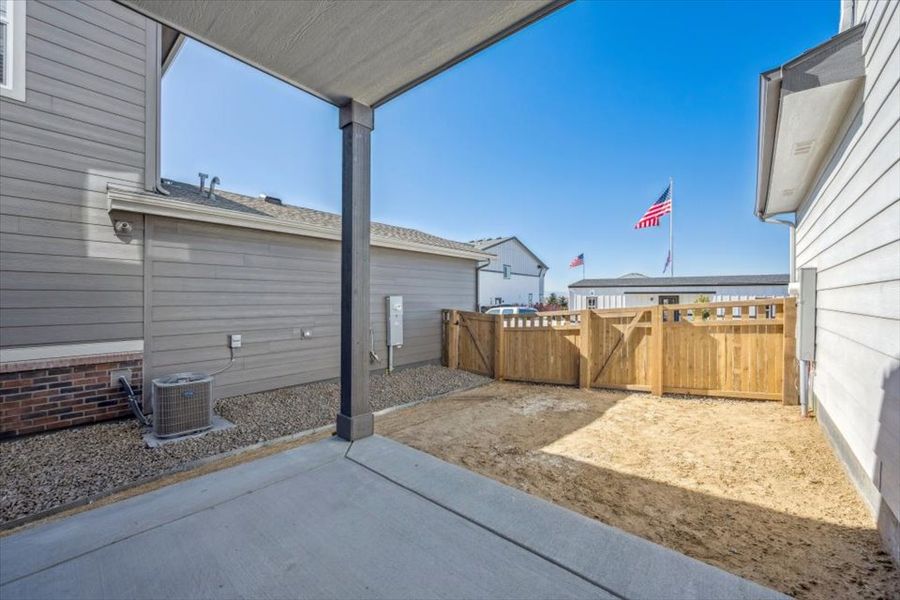 A building with a fence and a flag on the roof. A building with a fence and a flag on the roof.