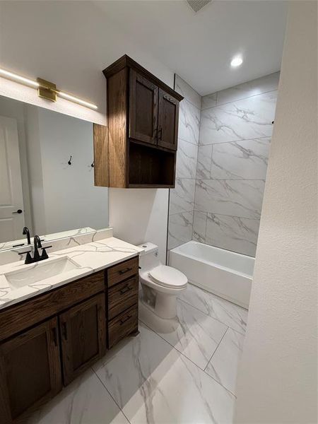Bathroom featuring light marble finish floors, vanity, shower / bathtub combination, and recessed lighting Bathroom featuring light marble finish floors, vanity, shower / bathtub combination, and recessed lighting