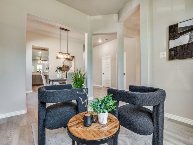 Living area featuring light wood-style floors and baseboards Living area featuring light wood-style floors and baseboards