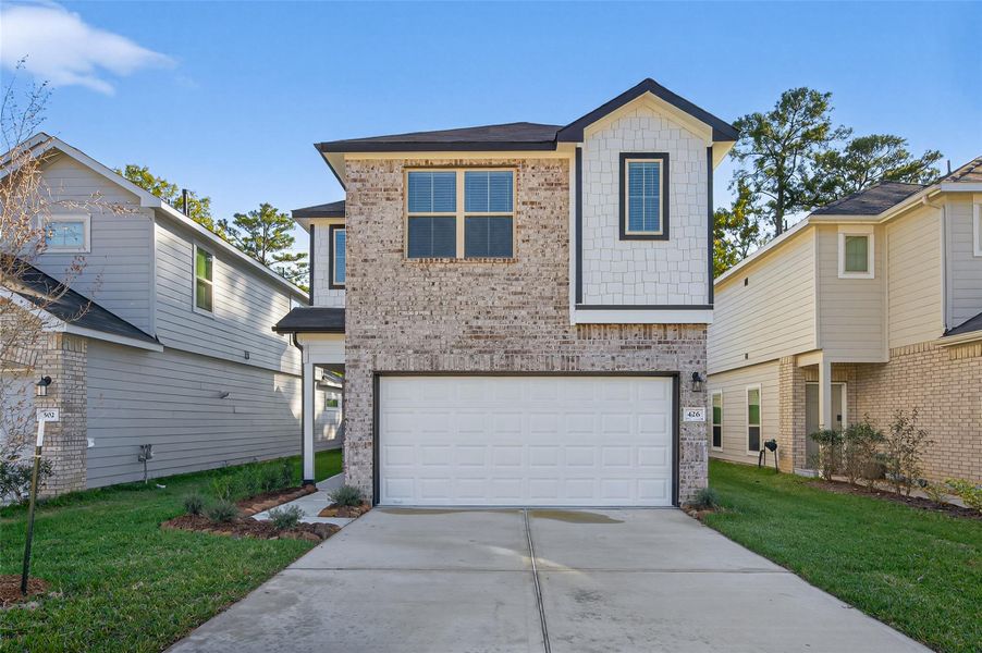 Front exterior of a new home in Woodland Lakes, Huffman, TX, highlighting curb appeal (Image 29). Front exterior of a new home in Woodland Lakes, Huffman, TX, highlighting curb appeal (Image 29).