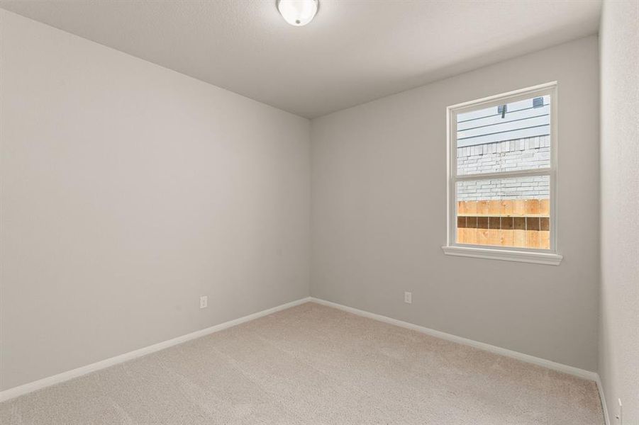 Your secondary bedroom features plush carpet, fresh paint, closet, and a large window that lets in plenty of natural lighting.