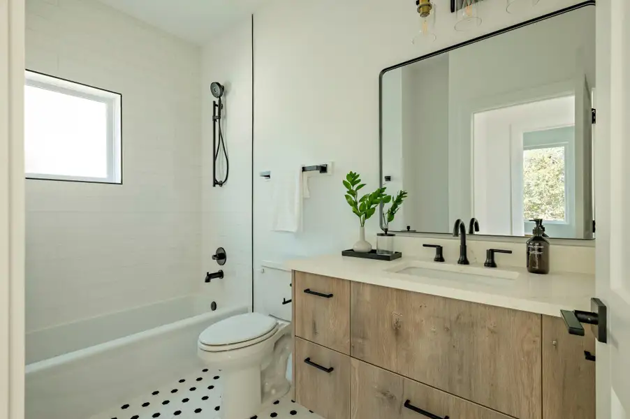 Secondary full bathroom with vanity, shower / bathtub combination, and tile patterned flooring Secondary full bathroom with vanity, shower / bathtub combination, and tile patterned flooring