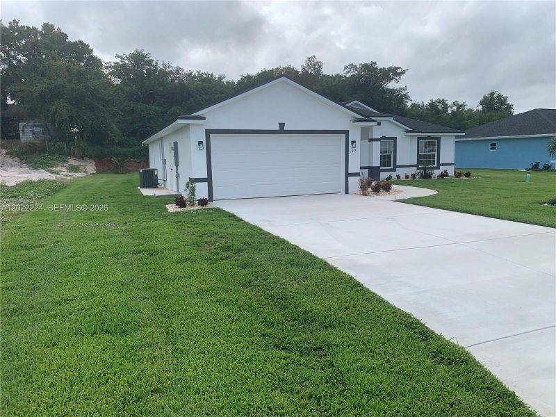 Front exterior of a new home in , Lake Placid, FL, highlighting curb appeal (Image 19).