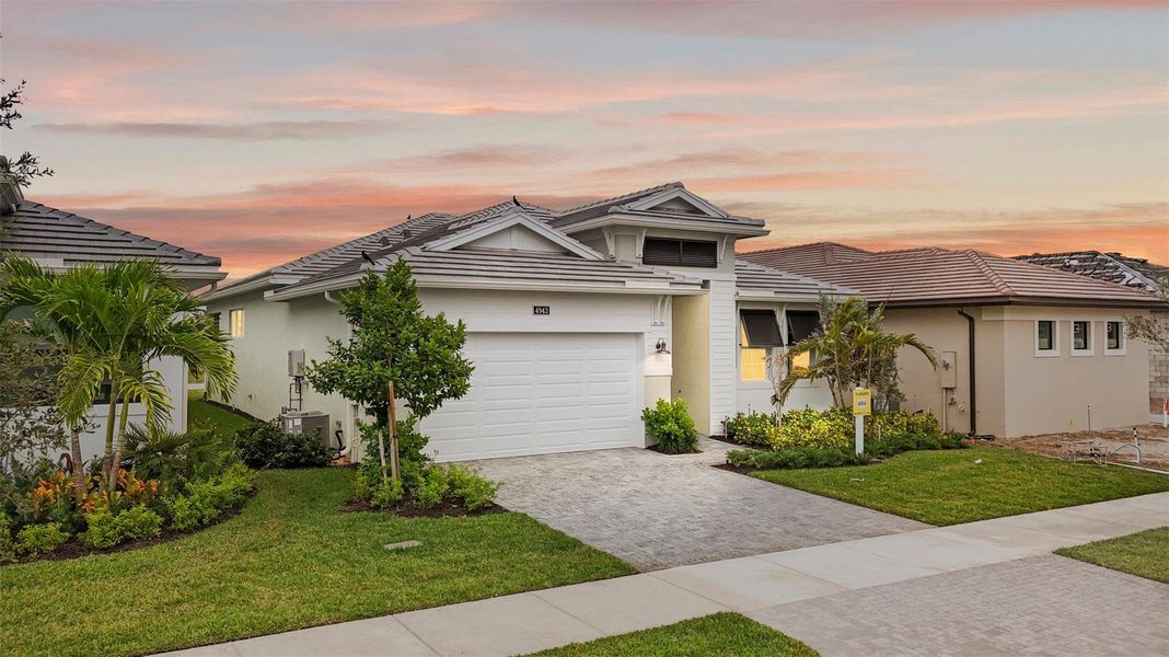 Front exterior of a new home in Cresswind Palm Beach at Westlake, Westlake, FL, highlighting curb appeal (Image 2).