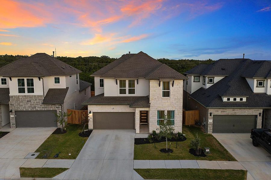 Clean architectural lines define this modern two-story residence with a stone accent facade.