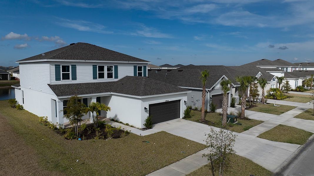 Front exterior of a new home in Central Park, Port St. Lucie, FL, highlighting curb appeal (Image 23).