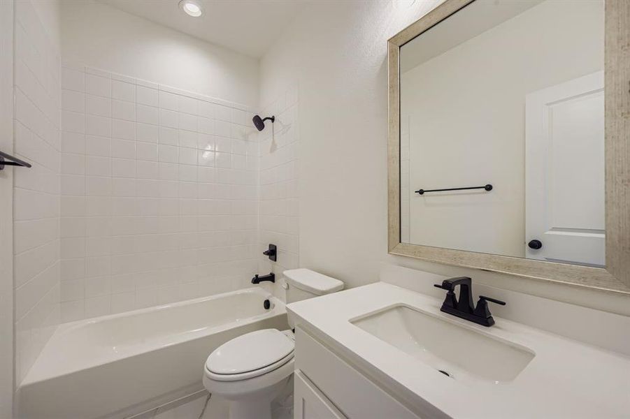 Bathroom featuring vanity, bathing tub / shower combination, and recessed lighting Bathroom featuring vanity, bathing tub / shower combination, and recessed lighting