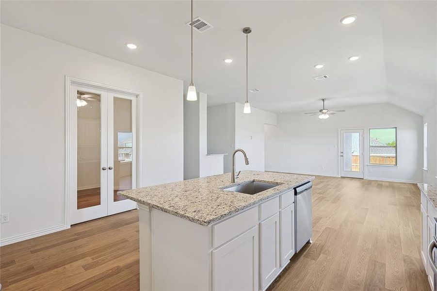 Kitchen featuring ceiling fan, white cabinets, sink, dishwasher, and light hardwood / wood-style floors