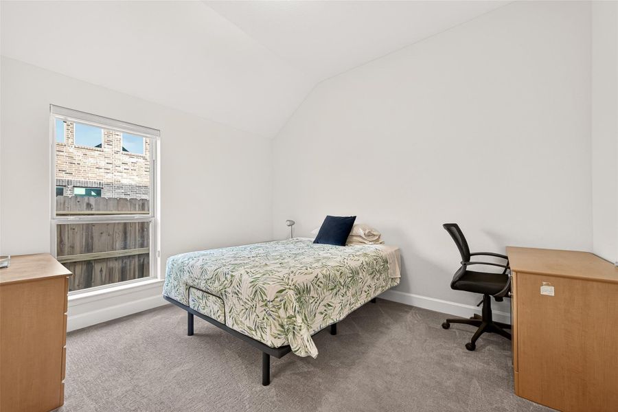 Convenient guest room with a private en-suite bath, offering comfort, privacy, and an ideal space for overnight guests or multi-generational living Convenient guest room with a private en-suite bath, offering comfort, privacy, and an ideal space for overnight guests or multi-generational living