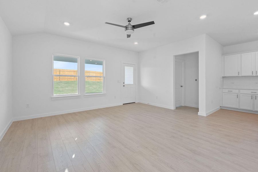 Unfurnished living room featuring light wood finished floors, recessed lighting, and ceiling fan