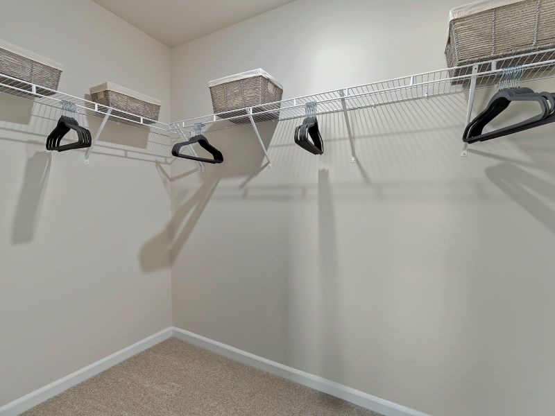 The large primary suite features an ensuite bath with dual sinks and a spacious walk-in closet.